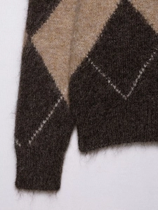 Detail of vintage argyle knit sweater showing soft fuzzy texture and brown diamond pattern