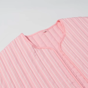 Detail of pink and white striped quilted loungewear with V-neck and size S label