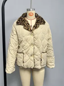 Detail of beige quilted jacket featuring leopard print faux fur collar and pocket trim
