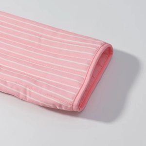 Detail of pink and white striped quilted fabric with high-quality edge piping finish