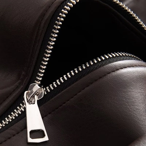 Macro shot of high-quality leather texture and silver metal zipper detail on jacket