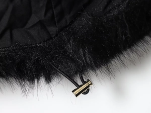 Detailed macro view of faux fur hood trim and premium golden metal drawstring toggles