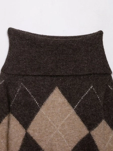 Close-up of argyle pattern knit sweater showing brown and camel diamond textures