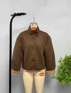 Detail of dark brown faux suede jacket featuring warm shearling lining and button closure