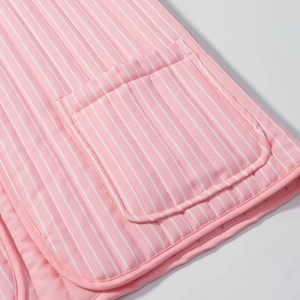 Detail of pink striped quilted jacket featuring soft cotton fabric and side pocket