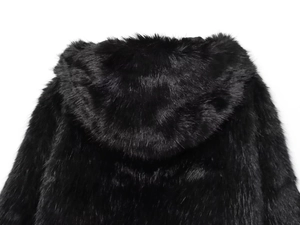 Detailed macro view of high-quality black faux fur texture on a hooded winter jacket