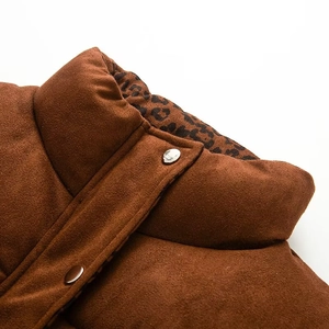 Detail of faux suede vest featuring leopard print lining and premium metal snap buttons