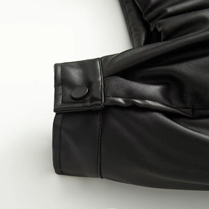 Chic oversized black faux leather bomber jacket with pleated cuffs and snap button detail
