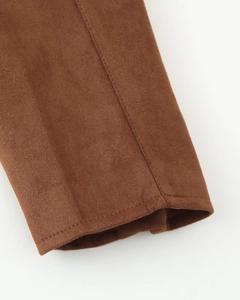 Makrodetail der braunen Wildlederjacke mit präzisen Nähten an der Manschette für Qualität