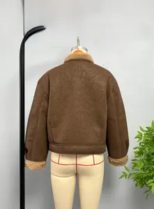 Detail of a brown suede bomber jacket with soft faux shearling lining and ribbed cuffs