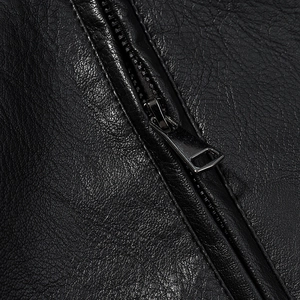 Detailed macro shot of premium black leather texture and smooth metal zipper closure