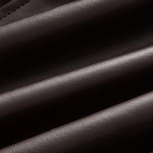 Close-up of premium dark brown lychee grain leather texture with neat stitching detail