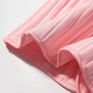 Detail of pink and white striped cotton fabric with clean piping and stitching