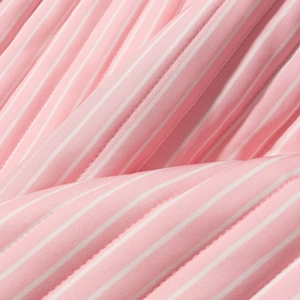 Detail of pink and white striped quilted fabric with vertical pleated texture and fine stitching