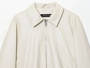 Close-up of beige faux leather aviator jacket featuring a lapel collar and metal zipper