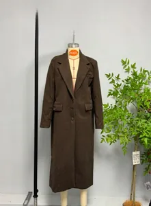 Detail of a dark brown wool coat showing the wide notched lapel and one-button closure