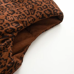 Detail of soft leopard print suede fabric with brown and black animal patterns