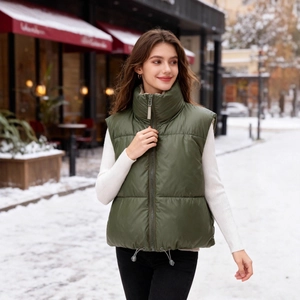 Women's dark green puffer vest with stand collar and adjustable drawstring hem