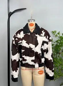 Close-up of cow pattern faux fur jacket with black leather collar and pocket trim