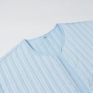 Vertical blue stripe quilted vest featuring a crew neck and front pockets