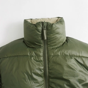 Olive green double-sided padded vest with high collar and beige lining detail