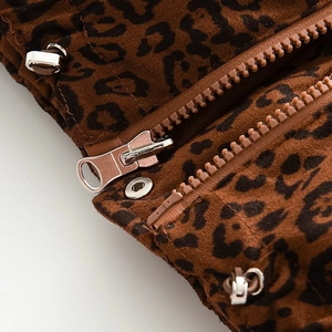 Detail of leopard print vest featuring metal zipper, snap buttons and elastic drawstring