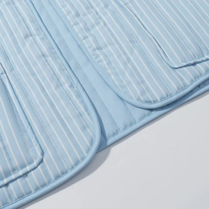Women's light blue striped quilted cotton vest with front pockets and round hemline