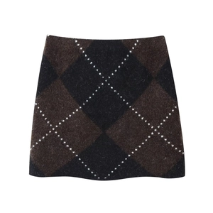 Detailed close-up of the vintage brown and black argyle knit skirt texture and pattern