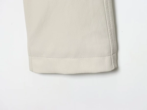 Detail of lychee textured faux leather with neat single-needle stitching on beige jacket