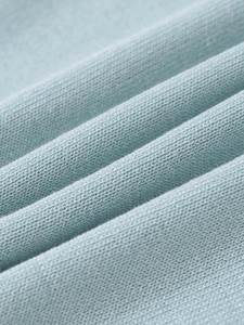 Close-up of light blue knit fabric showing fine texture and soft premium material