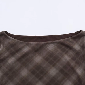 Detail of boat neck mesh top featuring vintage brown plaid pattern and sheer texture