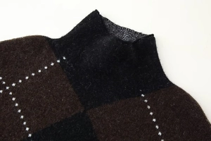 Macro detail of knit sweater featuring brown diamond pattern and fuzzy wool texture