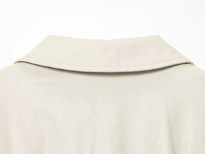 Close-up of cream faux leather bomber jacket collar with premium litchi texture