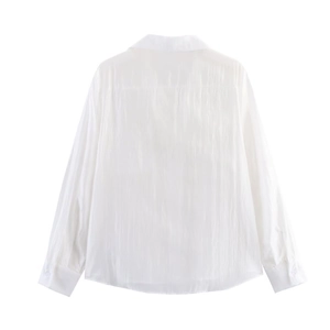 Detail view of the back of a white long-sleeve shirt with back yoke and clean shoulder seam