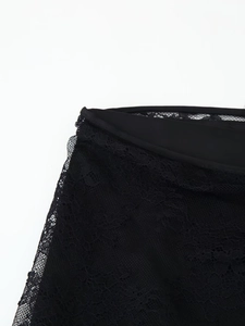 Close-up of black floral lace fabric with delicate mesh texture and neat edge binding