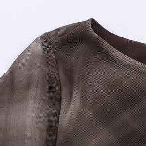 Close-up of semi-transparent dark coffee mesh fabric with fine double-stitched hem details