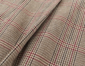 Close-up of thick high-waisted houndstooth wool blend fabric with vintage plaid texture