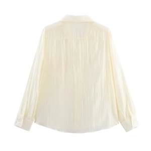 Back view of cream long sleeve shirt featuring elegant crinkle texture and button cuffs