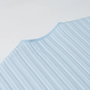 Detailed close-up of the blue and white vertical striped neckline with fine stitching