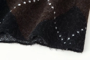 Macro shot of argyle knit fabric texture with soft wool-like brown and black pattern