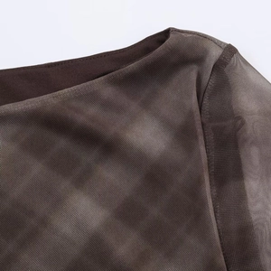 Detail shot of sheer brown mesh fabric with tie-dye pattern and textured neckline seam