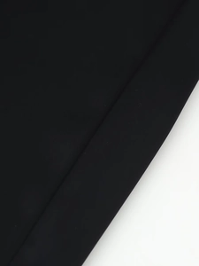 Macro shot of black satin fabric showing fine texture and seamless stitching detail
