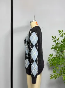 Macro detail of the classic argyle pattern knit sleeve on this vintage gray cardigan