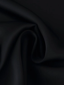 Detail of premium black silk-satin fabric showing its smooth texture and elegant drape