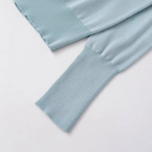 Women's light blue knit sweater with detailed rib knit cuffs and premium texture finish