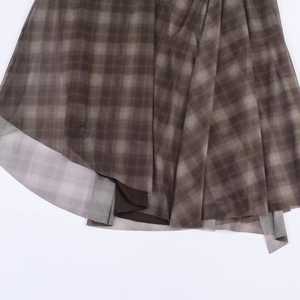 Detailed close-up showing the layered mesh fabric and plaid print of the brown midi skirt