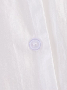 Macro shot of white shirt fabric detail with a light purple four-hole button texture