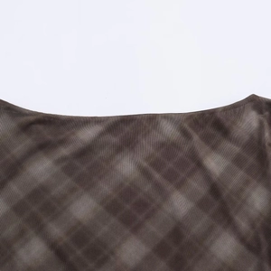 Detail of sheer mesh dress with deep brown marble print and smooth neckline finish