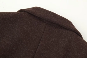 Detailed close-up of dark brown wool coat collar showing thick cashmere texture and fabric