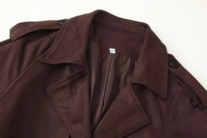 Close-up of brown suede coat featuring a lapel collar and shoulder strap detail